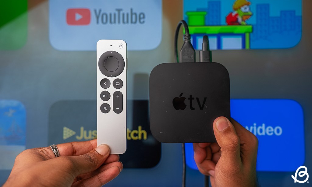 Apple TV and remote held nearby