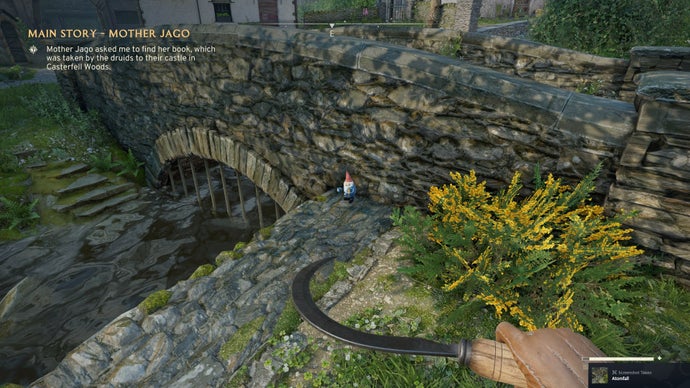 The player looks at a gnome sat next to the bridge in Wyndham Village in Atomfall