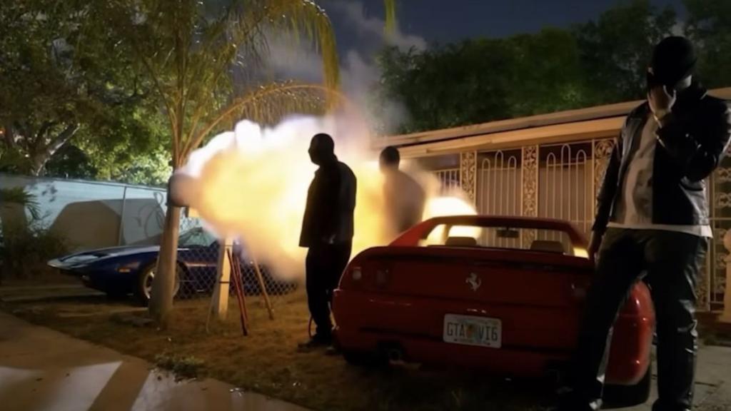 Red Ferrari with a license plate that reads 'GTA VI6' in the '2000 Excursion' music video